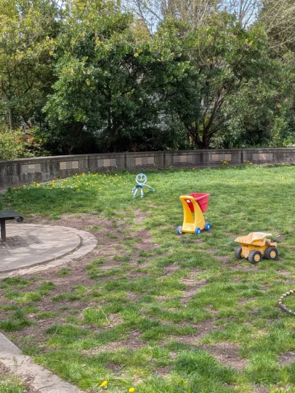Long-distance shot of a neighborhood park with children's toys in it.