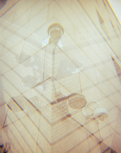 Multiple exposure showing many surveillance cameras mounted on corners of buildings
