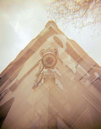 Looking up at a surveillance camera at the corner of a building