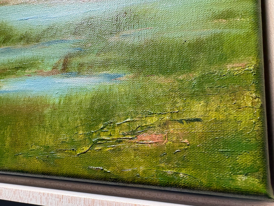 Detail photo showing palette knife markings, brushwork, textures and color variations in painted marsh grass in the lower right corner of an original coastal marsh oil painting by Tisha Mark, "A Day to Remember" 16"x20" oil on linen (2025). This vibrant Cape Cod inspired painting has a summery light blue sky with atmospheric pink cloud formations over a peaceful coastal marsh. The textured marsh grasses are green and a calm ocean is visible in the distance.