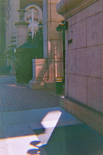 Surveillance camera at one of the entrances of Columbia main campus casting harsh shadow on the floor