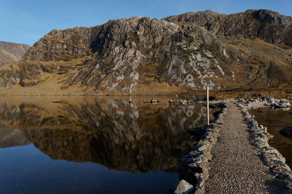Creag an Dubh Loch reflected in Dubh Loch from the middle of the causeway.
