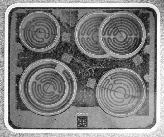A ceramic hob shot from above, with the individual heating elements visible in infrared through the black glass.