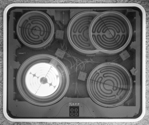 The ceramic hob with one of the heating elements on, shining in a bright white