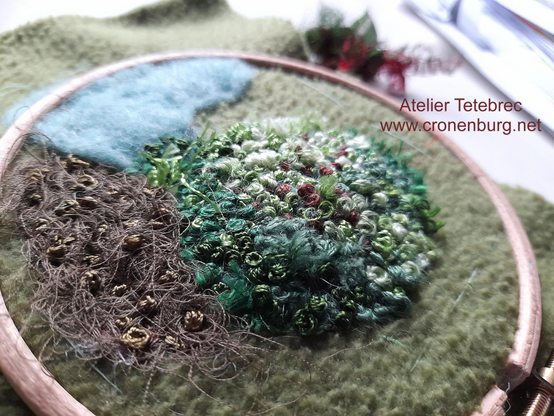 The whole hoop showing different areas for mosses. One is made in brown felt and only a few knots, like a dried moss. All the work in process was for an art work, I made some years before.