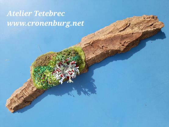 The whole artwork for an exhibition: A big piece of bark of a 200 years old felled oak is partly covered with moss and a grey lichen - but all plants are embroidered by me. The outer bark of the tree is so thick that it looks like a whole branch.