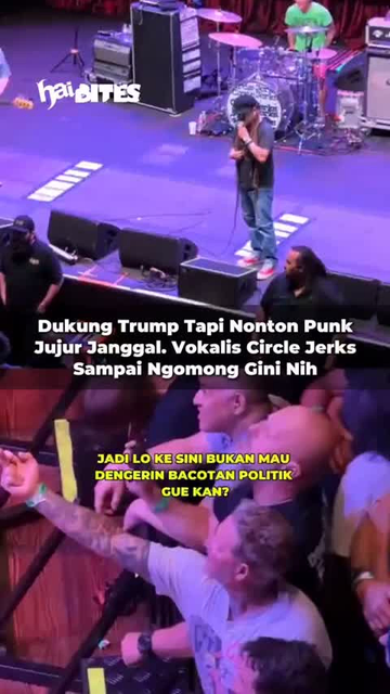 a singer on stage confronts a fan in a front row seat holding up his middle finger