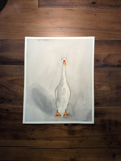 This is a watercolor painting with a warm gray background and a very tall white duck. It's bill and webbed feet in shades of orange and a pop of yellow stand out with all the gray. There is a shadow y the duck on the left side.