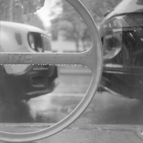 Raindrops hanging on the horizontal bar of a circle-shaped bike rack