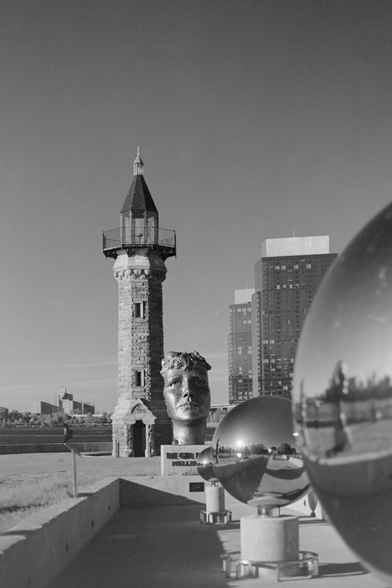 The lighthouse and the metal spheres that reflect the face sculptures