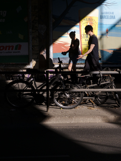 Diagonal light, a beer advert, a person walking through the scene,