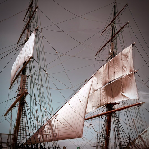 Masts, sails and rigging of Star of India. Background is dusky sky.