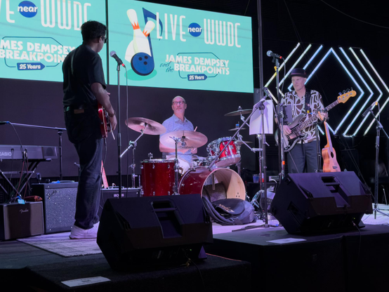 Three musicians warm up on stage.