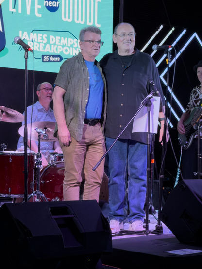 Chris Espinosa and James Dempsey stand on stage.