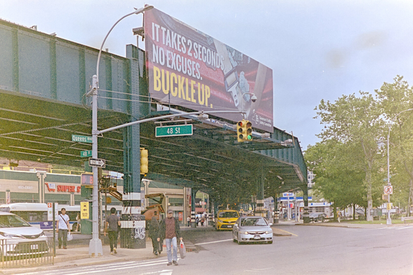 Giant billboard reminding drivers to wear seat belts mounted on steel elevated tracks for the 7 train