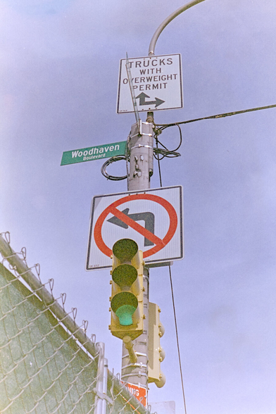 Traffic lights and signs at Woodhaven and Queens Blvd