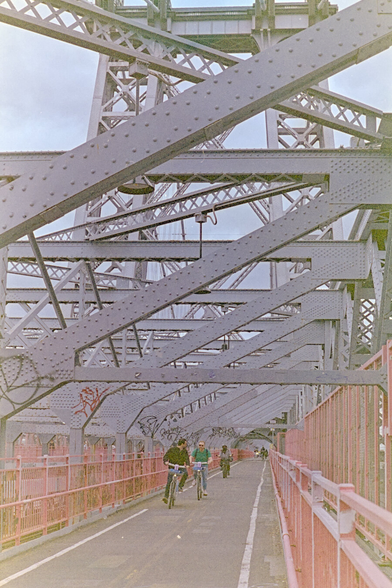 Bike path beneath the steel beams of Williamsburg Bridge. A few cyclists were approaching me.