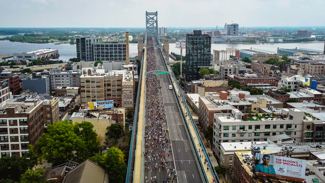 drone view of ben franklin bridge with people walking on it