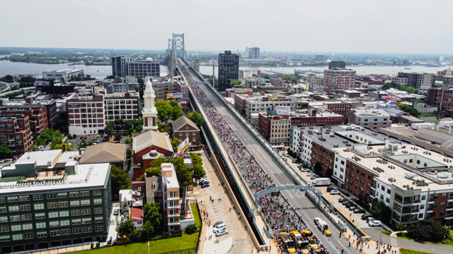 drone view of ben franklin bridge with people walking on it