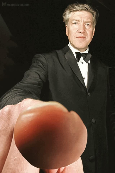 Animated GIF of David Lynch making a hypnotizing circular motion with his finger towards the viewer.