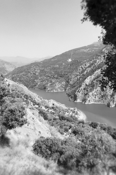 Black and white photo of the Canales Reservoir viewed from Las Lomas campsite. 