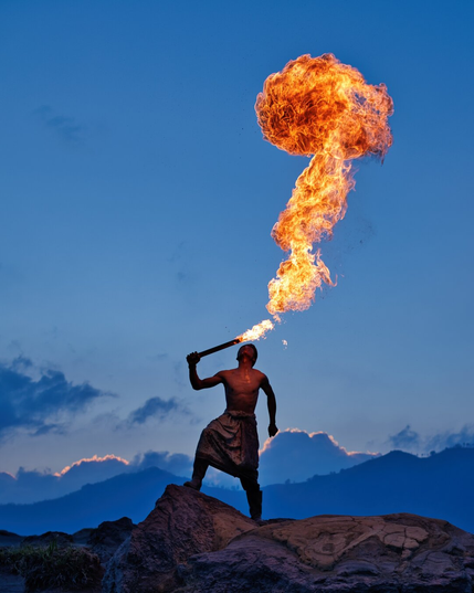 Portrait close-up as the man breathes more fire