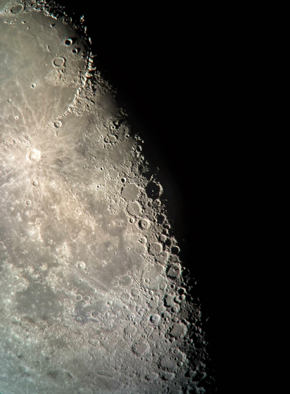 Closeup of the lunar surface, divided into its illuminated (left) and dark (right) sections by the terminator line running diagonally across the image. Crater details, particularly at the terminator, are crisp and sharp.

Shot on an iPhone 15 attached to a Celestron 130mm-aperture reflector telescope.