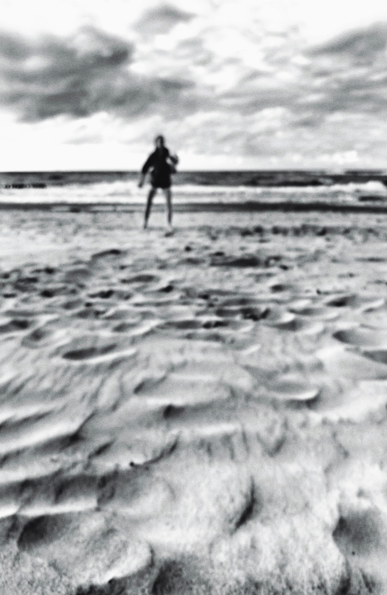 A unsharp pictute of a person at the beach of the baltic sea.